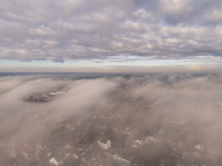 Above the Mist, Below the Clouds: Heavenly Drone Shot with a River in the Distance