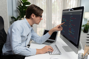 IT developer selecting by point on coding online software development information on pc comparing...