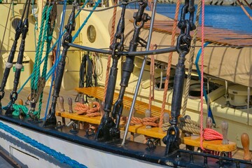 Rigging of a sailing ship. Sail ship lines, pulleys and fastening equipment secured for the day. Close-up view