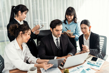 Diverse group of business analyst team analyzing financial data report paper on office table. Chart and graph dashboard by business intelligence analysis for strategic marketing planning Meticulous