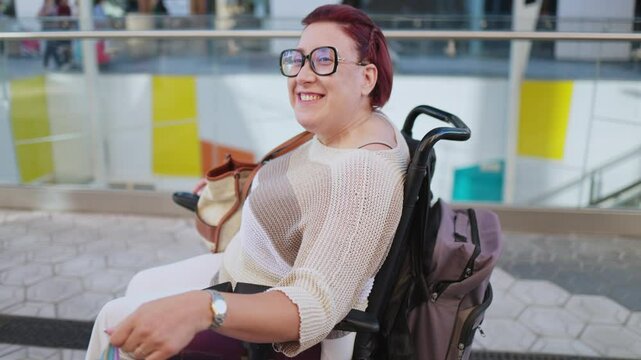 Happy disabled woman enjoying shopping trip in electric wheelchair