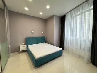 Stylish modern bedroom with large windows and elegant lighting