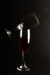 wine glass balanced on silhouette black background, Portrait