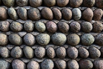 Stonewall texture closeup with egg shaped pebbles.
