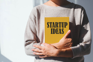 Person holding a yellow notebook with 