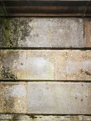Background: Uneven old wall with different colored patched clinker bricks. Closeup. Walls of...