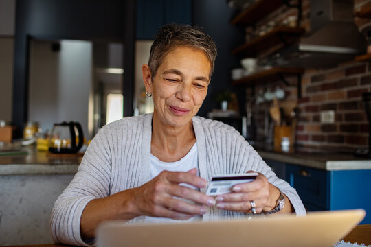 Woman making online banking payment with credit card and laptop