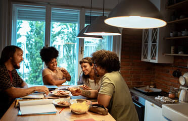 Group of young people studying together in modern home
