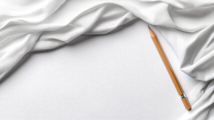 Wooden pencil on white fabric surface creating minimalistic aesthetic