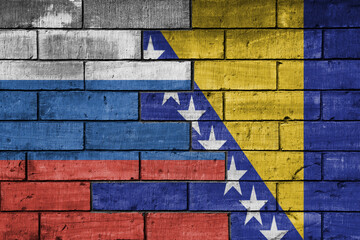 colourful painted big flag of russia and flag of bosnia and herzegovina on a massive old brick wall...