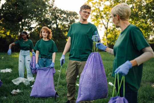 Group of volunteers collecting garbage in park