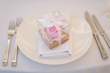 Table set for an event party or wedding reception. Beautiful ornate pink present box