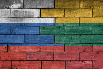Fototapeta premium colourful painted big flag of russia and flag of lithuania on a massive old brick wall background. concept