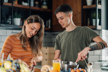 Portrait of a lesbian couple preparing breakfast in modern kitchen