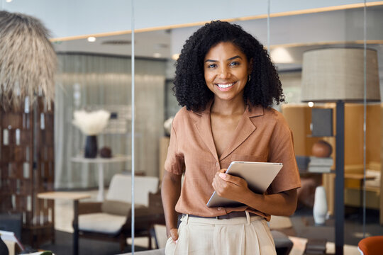 Happy confident young successful African American business woman lawyer, female advisor, company executive or entrepreneur standing in corporate work office holding digital tablet. Portrait.