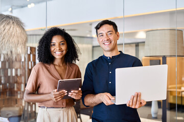 Young happy professional work team of two diverse confident female and male partners employees...