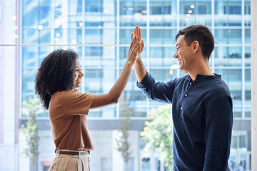 Happy diverse young team business people, two colleagues man and woman employees giving high five...