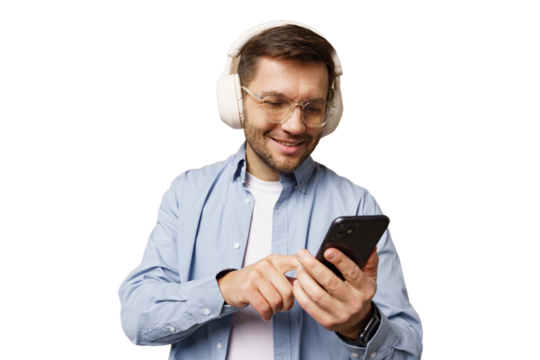 Man enjoying music with headphones while using smartphone indoors at home