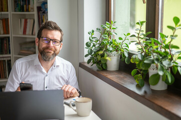 Millennial businessman working at desk in office