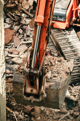 Fototapeta premium Excavator removing debris from a demolition site.