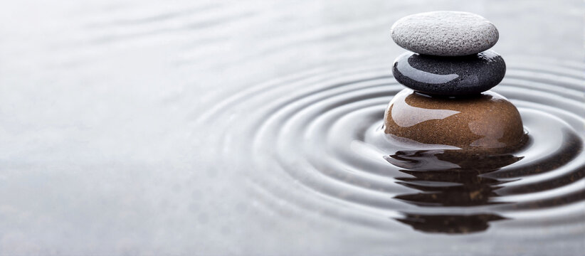 Stacked stones on calm water