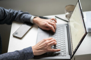 Woman working on laptop and using mobile  work from home