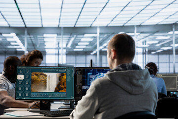 Engineer in server hub workspace making AI software turning text prompt into photos. System...