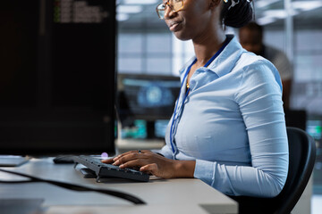 Admin implementing cybersecurity measures to protect data center assets and information. Employee...