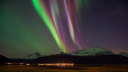 Aurora Borealis over Lyngen mountains in late autumn in northern Norway