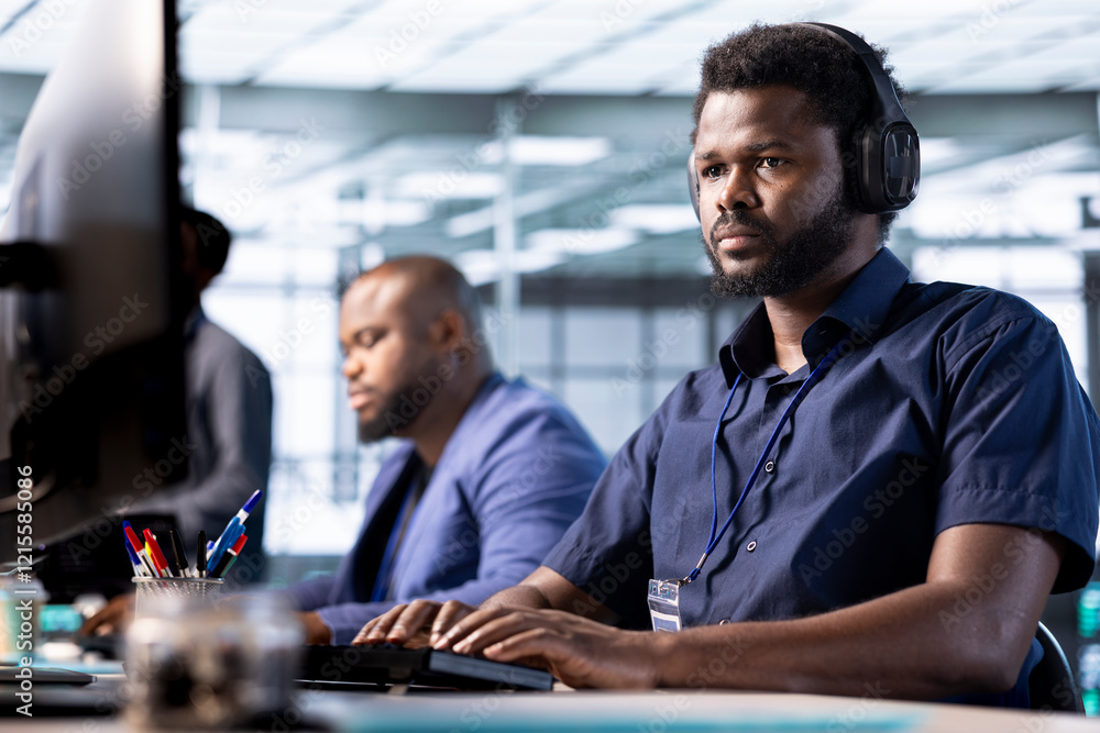 Poster man in data center wearing headphones to hear songs while creating technical documentation for softw