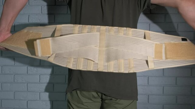 Strong back belt support on man. A man with health problems wearing the belt support.