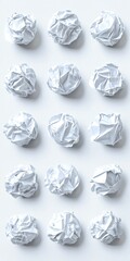 A grid of crumpled white paper balls on a light background.
