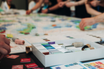 Process of playing tabletop board game on the table, fun with friends and family in room indoors,...