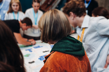 Process of playing tabletop board game on the table, fun with friends and family in room indoors, board game party concept, company group of students adults play board games, roll the dice on game map