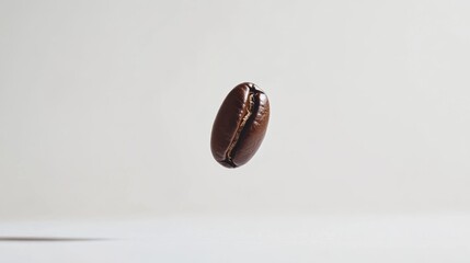 A few coffee beans gently falling, surrounded by space on a white background for an airy, light composition.