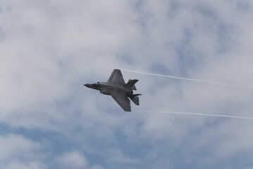 F35 doing stunts at air show and breaking sound barrier. Sonic boom