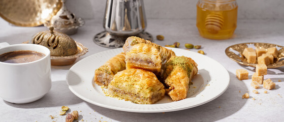 Plate of tasty baklava on light background