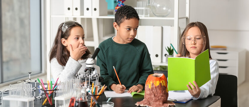 Little children studying Chemistry in science classroom
