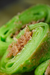 Coconut grated Pandan crepe know as Kuih Dadar. It is combination of sweet filling made from grated...