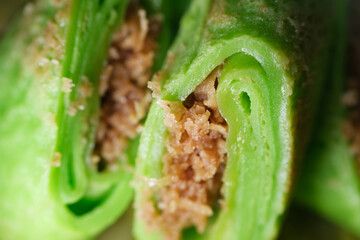 Coconut grated Pandan crepe know as Kuih Dadar. It is combination of sweet filling made from grated...