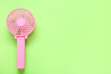 Modern manual fan on green background
