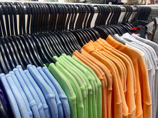 T-shirts hanging neatly in a clothing store,display in a clothing store