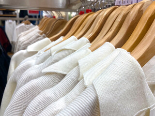 White Knitwear on Wooden Hangers - Close-U