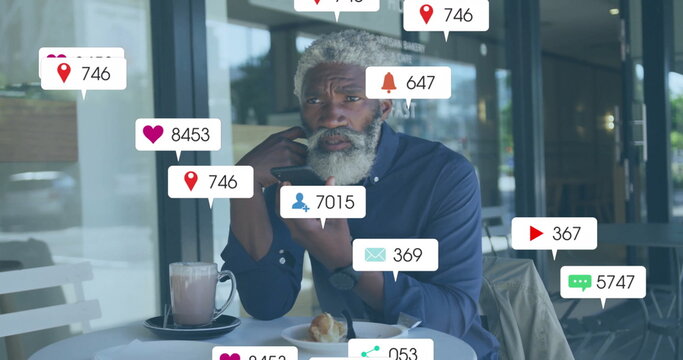 Image of social media notifications over senior african american man using smartphone
