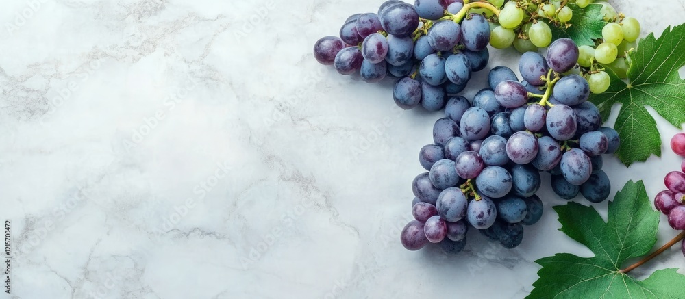 Aufkleber fresh clusters of green and red grapes on a marble countertop with copy space for text.