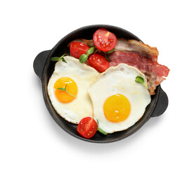 Pan with tasty fried eggs, tomatoes and bacon on white background. Top view