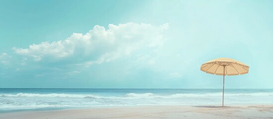 Beach scene with a solitary yellow umbrella under a clear sky and gentle waves, featuring soft pastel tones and ample copy space.