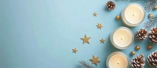 Candles with pine cones and decorative stars on a light blue background with Copy Space for text