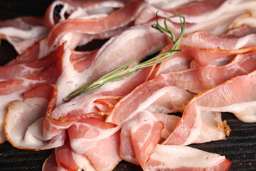 Slices of tasty fresh raw bacon. Closeup