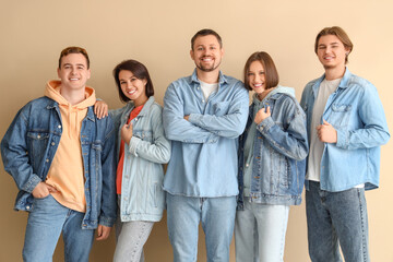Obraz premium Group of young people in denim clothes on beige background